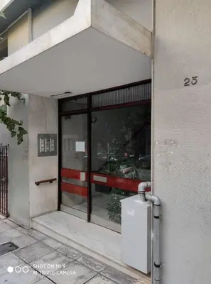 a facade of a building with a refrigerator in front at Minimal apartment on the shadow of the Acropolis in Athens