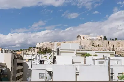 a view of the acropolis from the roofs of buildings at Minimal apartment on the shadow of the Acropolis in Athens