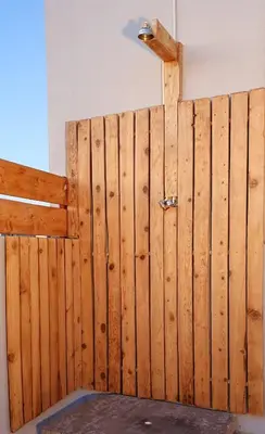 a wooden fence with a door in a room at Acropolis View Apartment in the Heart of Monastiraki in Athens