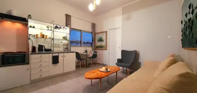 a living room with a couch and a table at Acropolis View Apartment in the Heart of Monastiraki in Athens