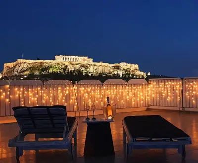 a bunch of lights on a fence with a building at Acropolis View Apartment in the Heart of Monastiraki in Athens