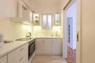 a white kitchen with a sink and a stove at NEW! Bright & Remodeled 1Bed apt 2min Walk to Acropolis in Athens