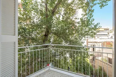 a balcony with a tree and a white railing at NEW! Bright & Remodeled 1Bed apt 2min Walk to Acropolis in Athens