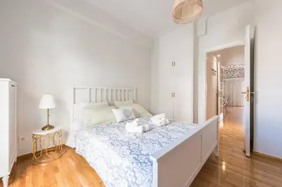 a white bedroom with a large bed in a room at NEW! Bright & Remodeled 1Bed apt 2min Walk to Acropolis in Athens