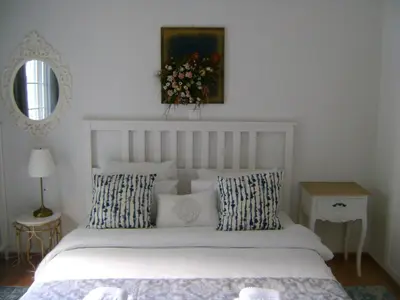 a bedroom with a white bed with pillows and a mirror at NEW! Bright & Remodeled 1Bed apt 2min Walk to Acropolis in Athens