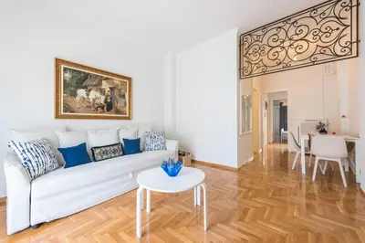 a living room with a white couch and a table at NEW! Bright & Remodeled 1Bed apt 2min Walk to Acropolis in Athens