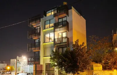 a tall building with balconies on it at night at Ma Maison No3 Downtown Loft,320Mbps,Acropolis Walk in Athens