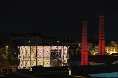 a lit up building with two smoke stacks at night at Ma Maison No3 Downtown Loft,320Mbps,Acropolis Walk in Athens