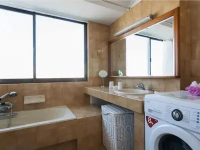 a bathroom with a washing machine and a sink at Luxury Athenian Riviera Apartment 135 sqm at Voula in Athens