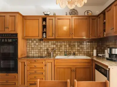 a kitchen with wooden cabinets and a sink at Luxury Athenian Riviera Apartment 135 sqm at Voula in Athens
