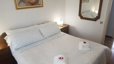 a bedroom with a bed with towels on it at Luxury Athenian Riviera Apartment 135 sqm at Voula in Athens