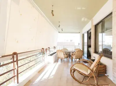 a balcony with a table and chairs on it at Luxury Athenian Riviera Apartment 135 sqm at Voula in Athens