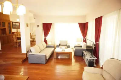 a living room with a couch and chairs and a table at Luxury Athenian Riviera Apartment 135 sqm at Voula in Athens