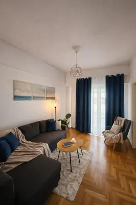 a living room with a couch and a table at Elegant Apartment near Acropolis Walk to Plaka & Metro in Athens