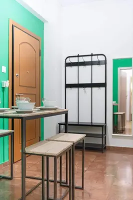 a room with a table and chairs and a mirror at Elegant Apartment near Acropolis Walk to Plaka & Metro in Athens