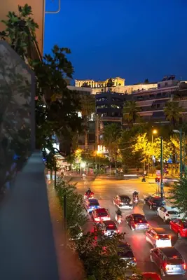a busy city street at night with cars parked at Elegant Apartment near Acropolis Walk to Plaka & Metro in Athens