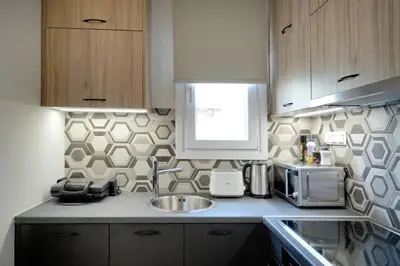 a kitchen with a sink and a microwave at Odyssey Residence in Athens