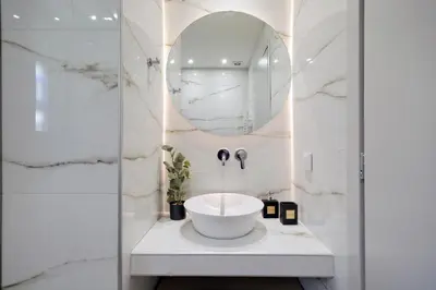 a bathroom with a sink and a mirror at Odyssey Residence in Athens