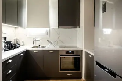 a kitchen with a sink and a stove at Odyssey Residence in Athens