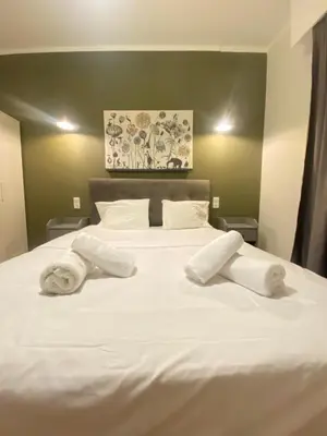 a white bed with two towels on top of it at Athens City Themis 10 in Athens