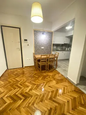 a dining room with a table and chairs on a wooden floor at Athens City Themis 10 in Athens