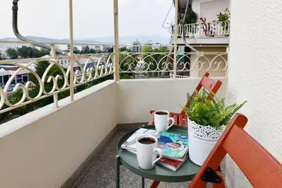 a table with two cups of coffee on a balcony at Athens City Themis 10 in Athens