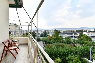 a balcony with two chairs and a view of the city at Athens City Themis 10 in Athens