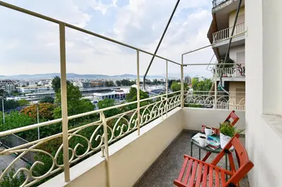 a balcony with a bench and a view of the city at Athens City Themis 10 in Athens