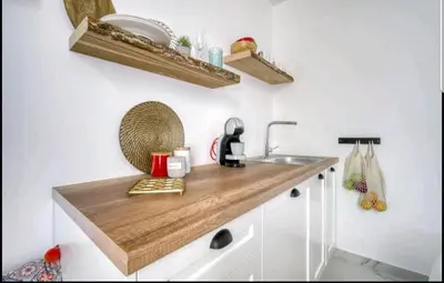 a kitchen with a wooden counter top and a sink at Acropolis stunning view Penthouse in Plaka for 2! in Athens