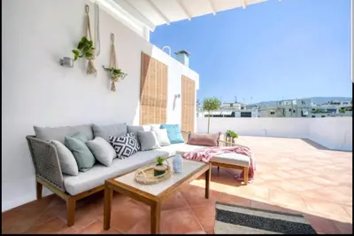 a living room with a couch and a table at Acropolis stunning view Penthouse in Plaka for 2! in Athens