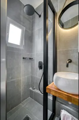 a bathroom with a sink and a shower at Acropolis stunning view Penthouse in Plaka for 2! in Athens