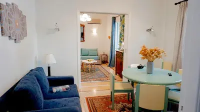 a living room with a blue couch and a table at Comfortable Apartment in Kallithea by Athenian Homes in Athens