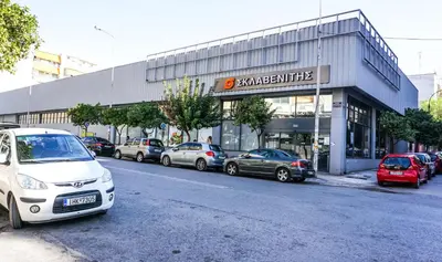 a parking lot with cars parked in front of a building at Comfortable Apartment in Kallithea by Athenian Homes in Athens