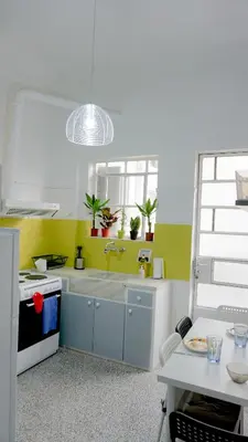 a kitchen with a sink and a window and a table at Comfortable Apartment in Kallithea by Athenian Homes in Athens