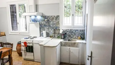 a white kitchen with a sink and a stove at A Happy Stay at Edem Beach by Athenian Homes in Athens