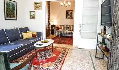 a living room with a couch and a table at A Happy Stay at Edem Beach by Athenian Homes in Athens
