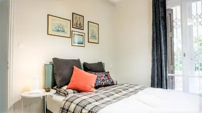 a bedroom with a bed with colorful pillows on it at A Happy Stay at Edem Beach by Athenian Homes in Athens