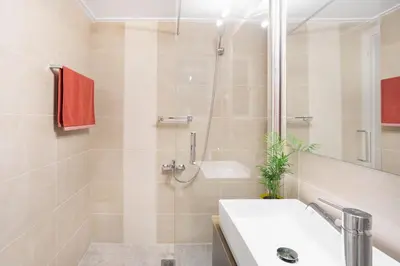 a bathroom with a shower and a sink and a tub at A Short Walk to Syntagma and Plaka by Athenian Homes in Athens