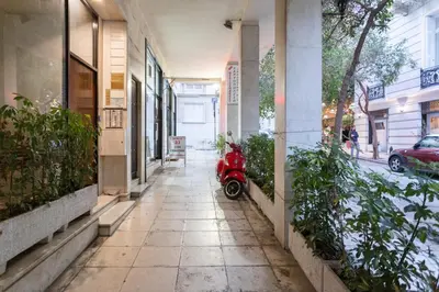 a red scooter parked on the side of a building at A Short Walk to Syntagma and Plaka by Athenian Homes in Athens