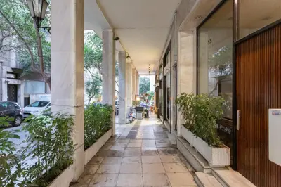 an empty sidewalk in front of a building at A Short Walk to Syntagma and Plaka by Athenian Homes in Athens