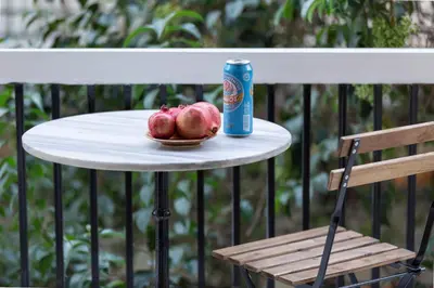 a table with a can of pomegranates and a chair at A Short Walk to Syntagma and Plaka by Athenian Homes in Athens
