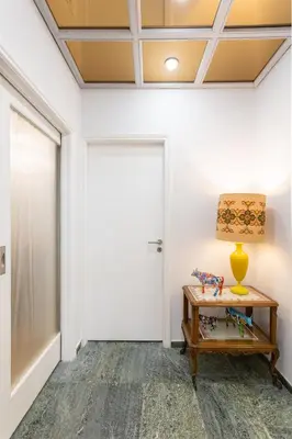 a hallway with a door and a table with a lamp at A Short Walk to Syntagma and Plaka by Athenian Homes in Athens
