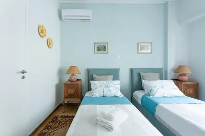 a room with two beds and two tables with lamps at A Short Walk to Syntagma and Plaka by Athenian Homes in Athens