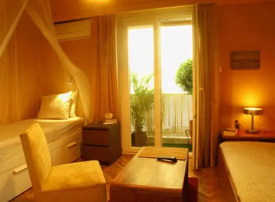 a hotel room with a bed and a window at Homey and calm yet central (by the Hilton) in Athens