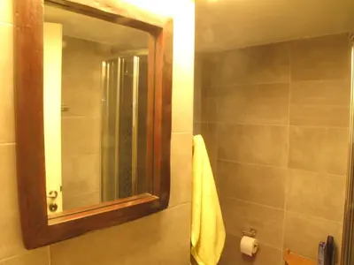 a bathroom with a mirror and a yellow towel at Homey and calm yet central (by the Hilton) in Athens