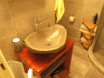 a bathroom with a sink on a wooden table at Homey and calm yet central (by the Hilton) in Athens