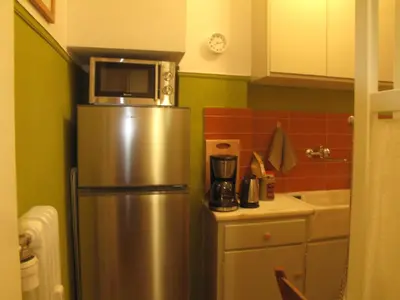 a kitchen with a stainless steel refrigerator with a microwave on top at Homey and calm yet central (by the Hilton) in Athens