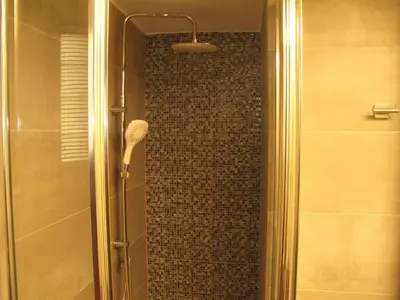 a shower with a glass door with a shower at Homey and calm yet central (by the Hilton) in Athens