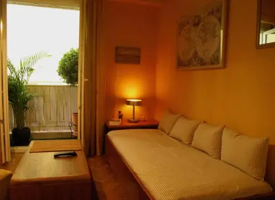 a living room with a bed and a window at Homey and calm yet central (by the Hilton) in Athens