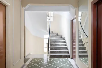 a winding staircase in a home with a white wall at Studio with sunny balcony in Exarcheia in Athens